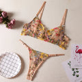 Women's floral polyester bikini underwear set in pink, showing bralette and briefs.