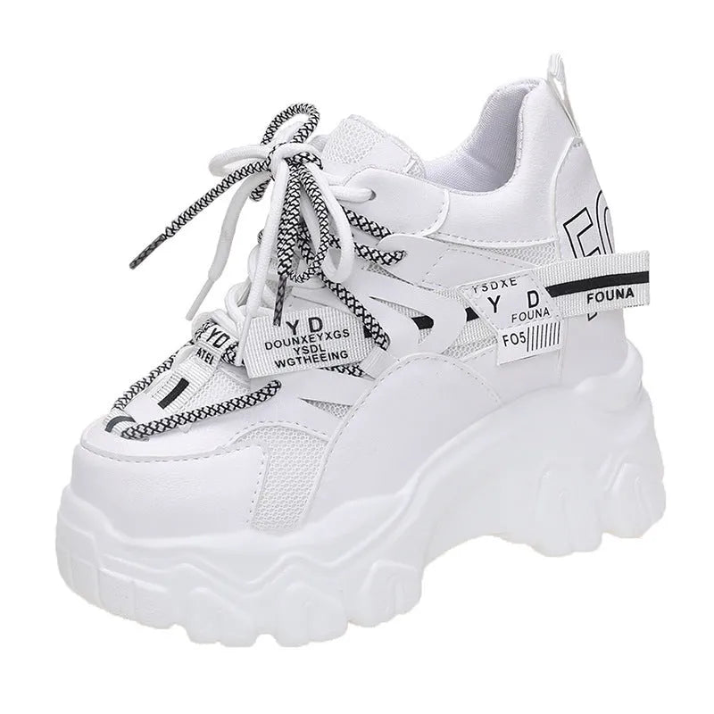 Women's white mesh platform sports shoes with cross strap and a high rubber sole.