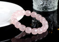 Pink natural bamboo crystal bracelet with 11-12mm geometric barrel beads on a wrist.