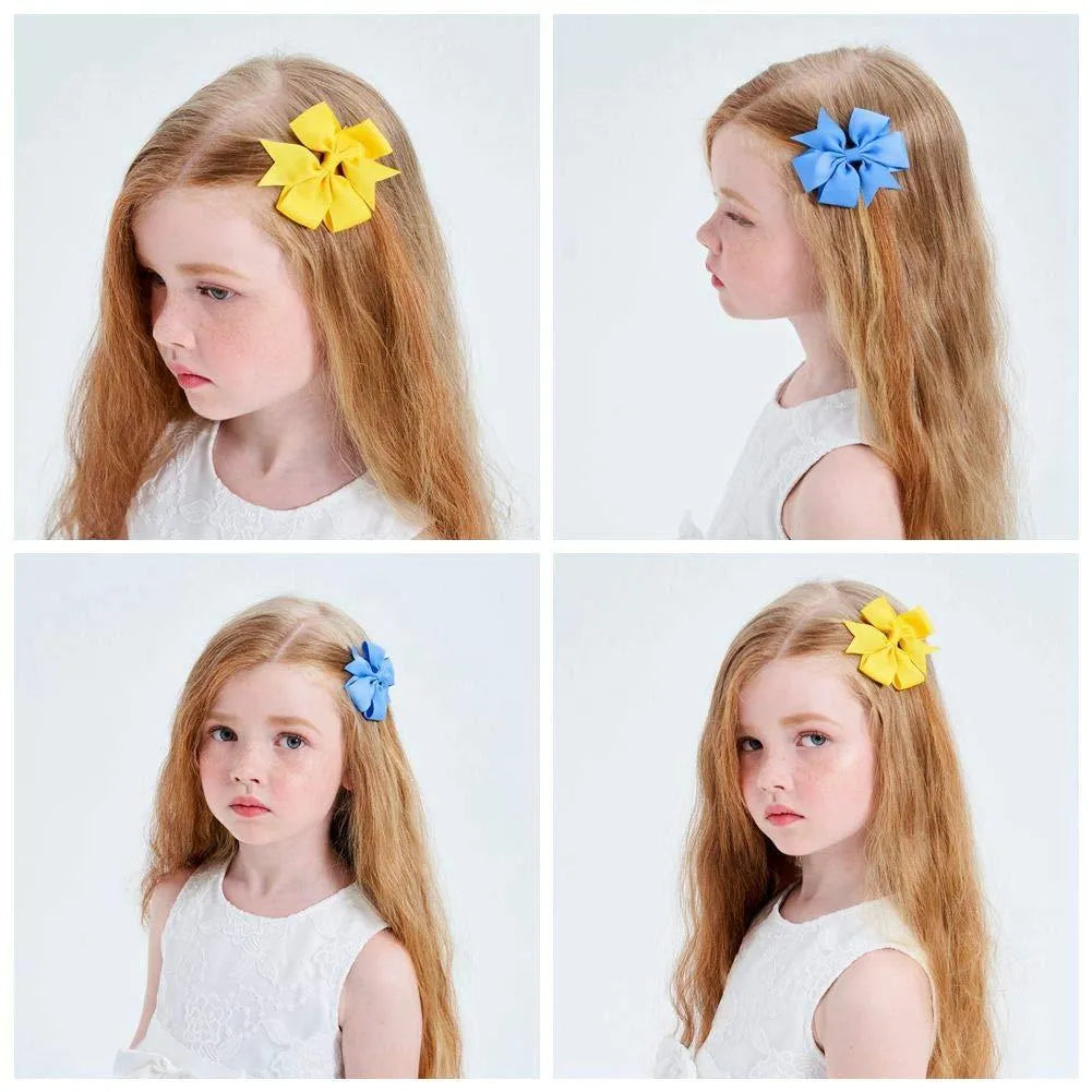 Assorted colourful handmade grosgrain ribbon pinwheel hair bows with alligator clips for toddlers.