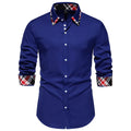 Man wearing a blue plaid long sleeve shirt with a triangle collar