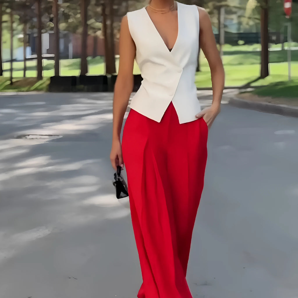 Women's beige two-piece set with deep V-neck sleeveless top and high-waisted wide leg trousers.