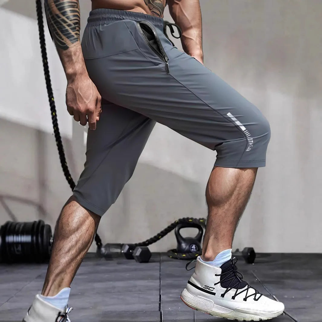 Men's cropped nylon sports trousers in straight cut available in black, blue, gray and khaki