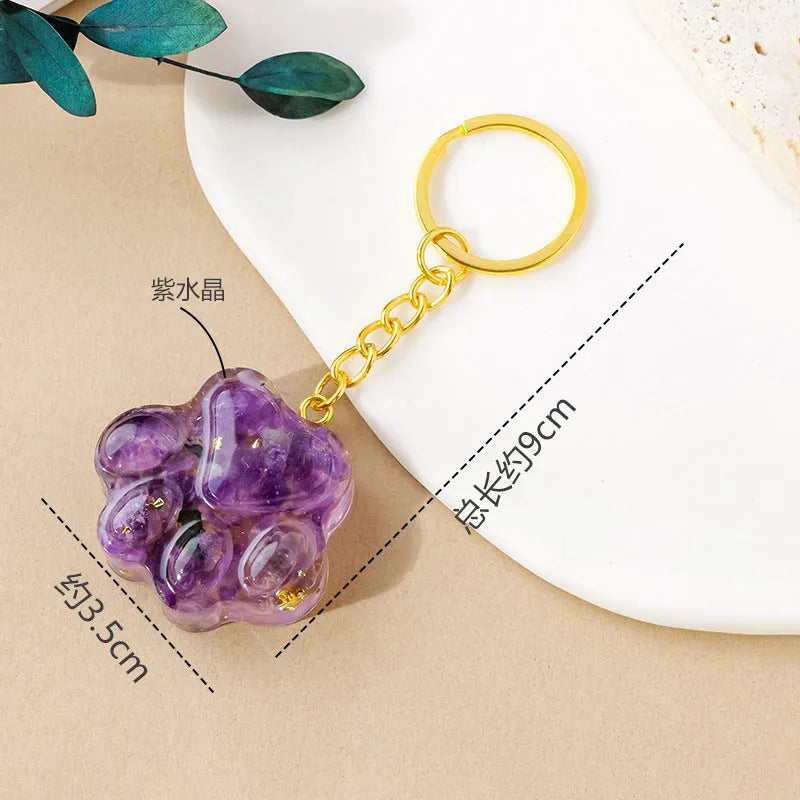 Small natural crystal cat's paw claw charm on a metal loop keychain