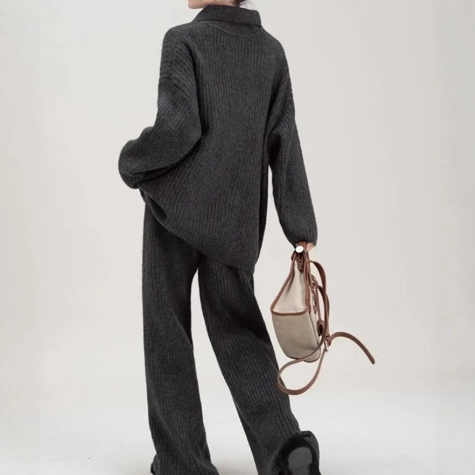 Beige sweater suit two-piece set with a knitted top and casual trousers on a hanger.
