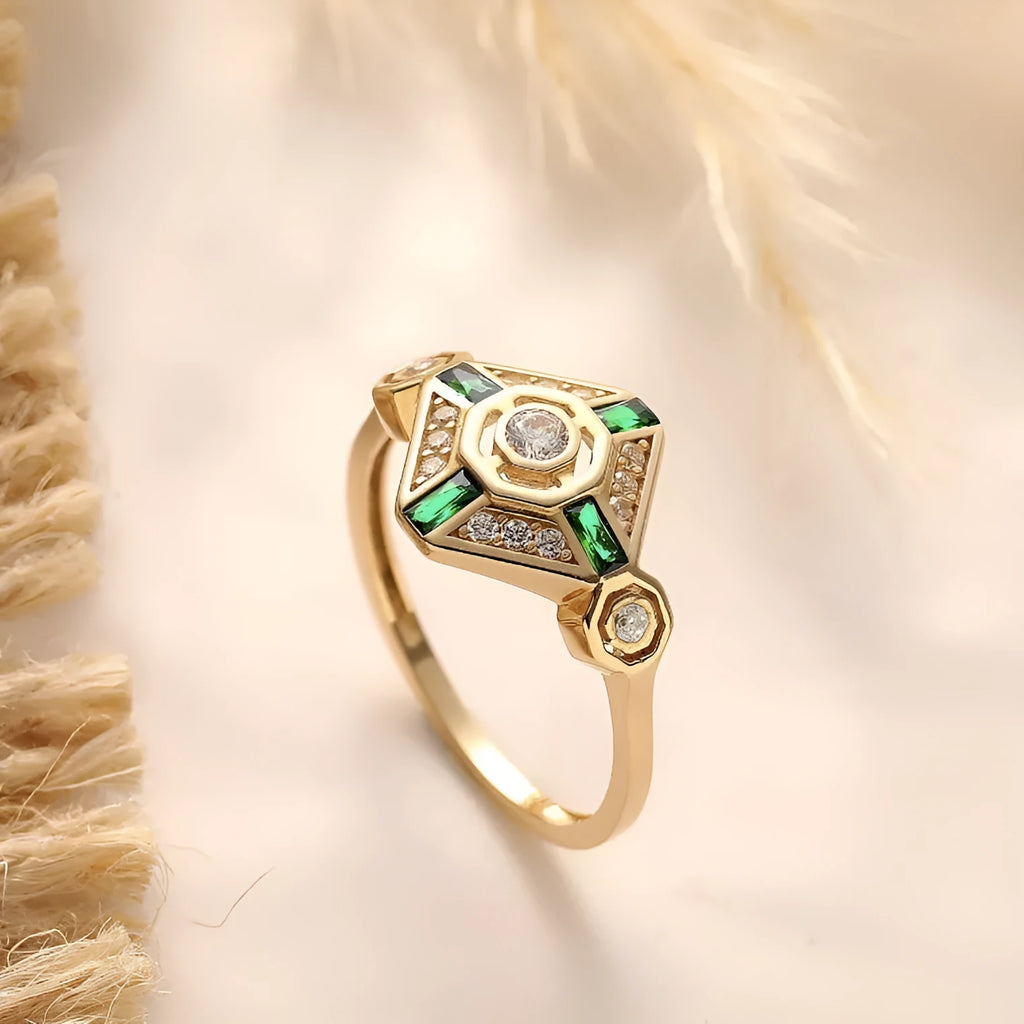 Square-shaped women's ring with a green emerald gemstone on a geometric band.