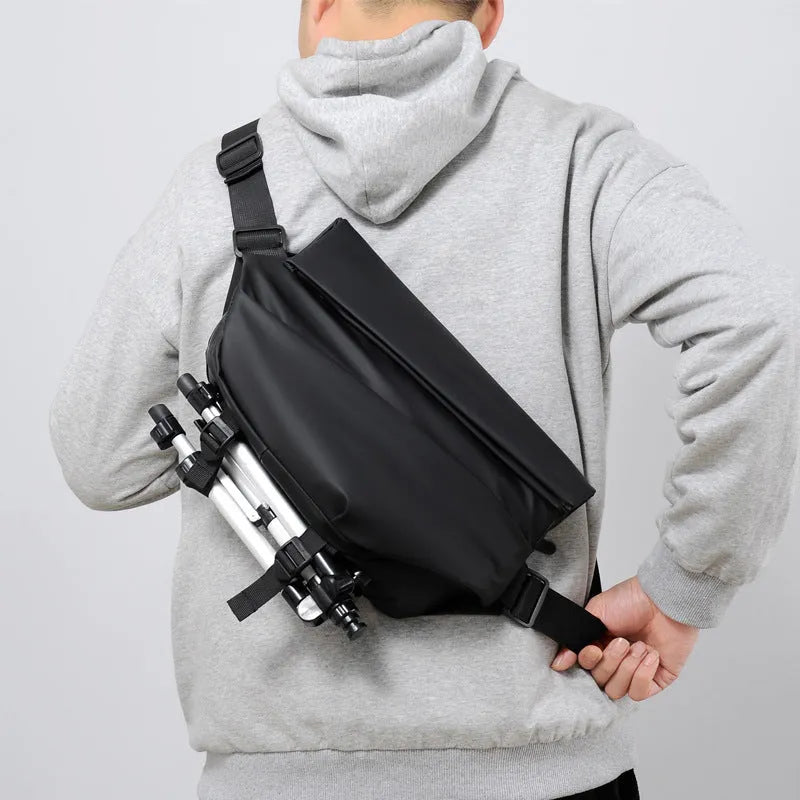 Grey PU leather men's crossbody bag with a shoulder strap, shown with open compartment for phone and documents.