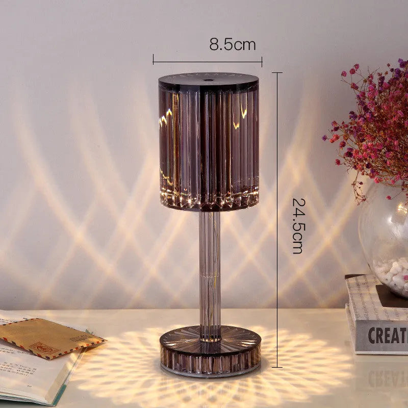 Amber K9 crystal table lamp with double-layered lampshade on a modern bedside table, warm LED light on medium brightness