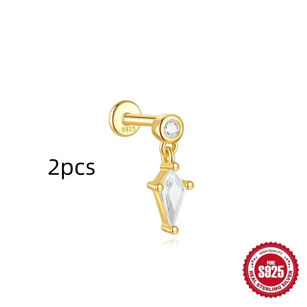 Geometric kite-shaped sterling silver stud earrings with rhinestones and a gold chain tassel.
