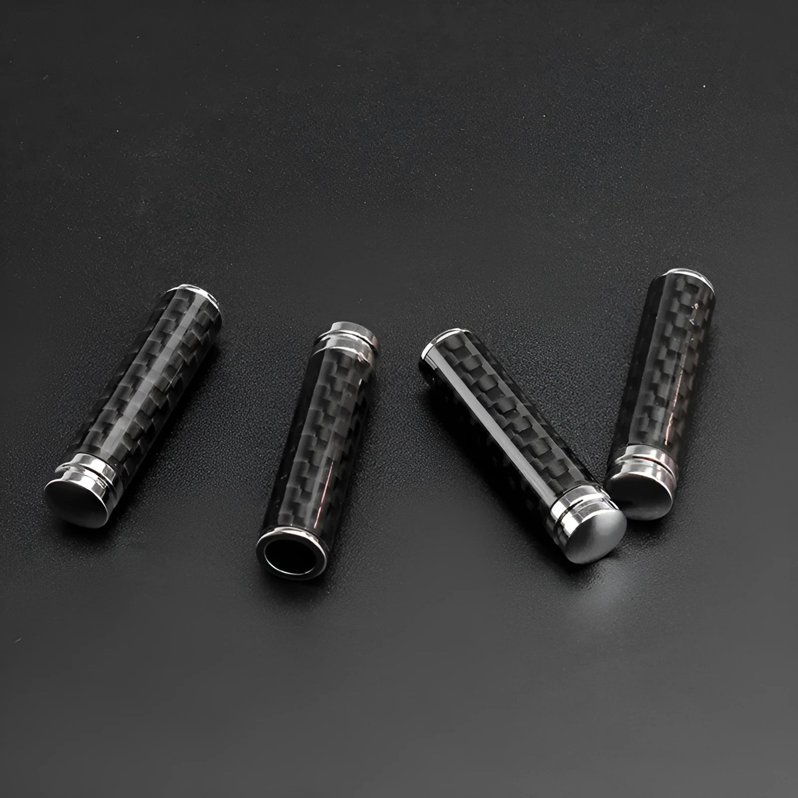 Set of four carbon fibre and metal composite car door lift covers for universal interior fitment.