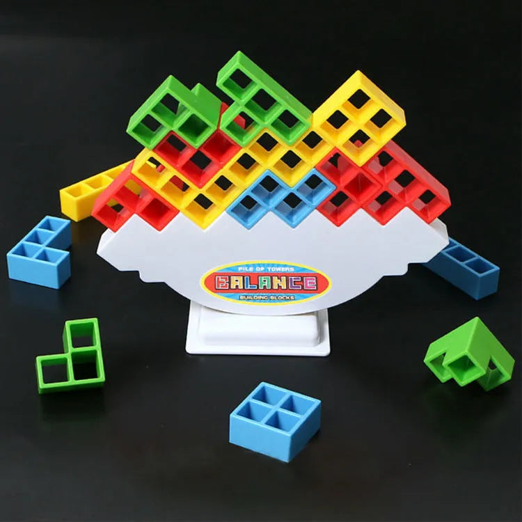 Plastic balance stacking board game with 16 coloured building blocks, chassis, and base on table.