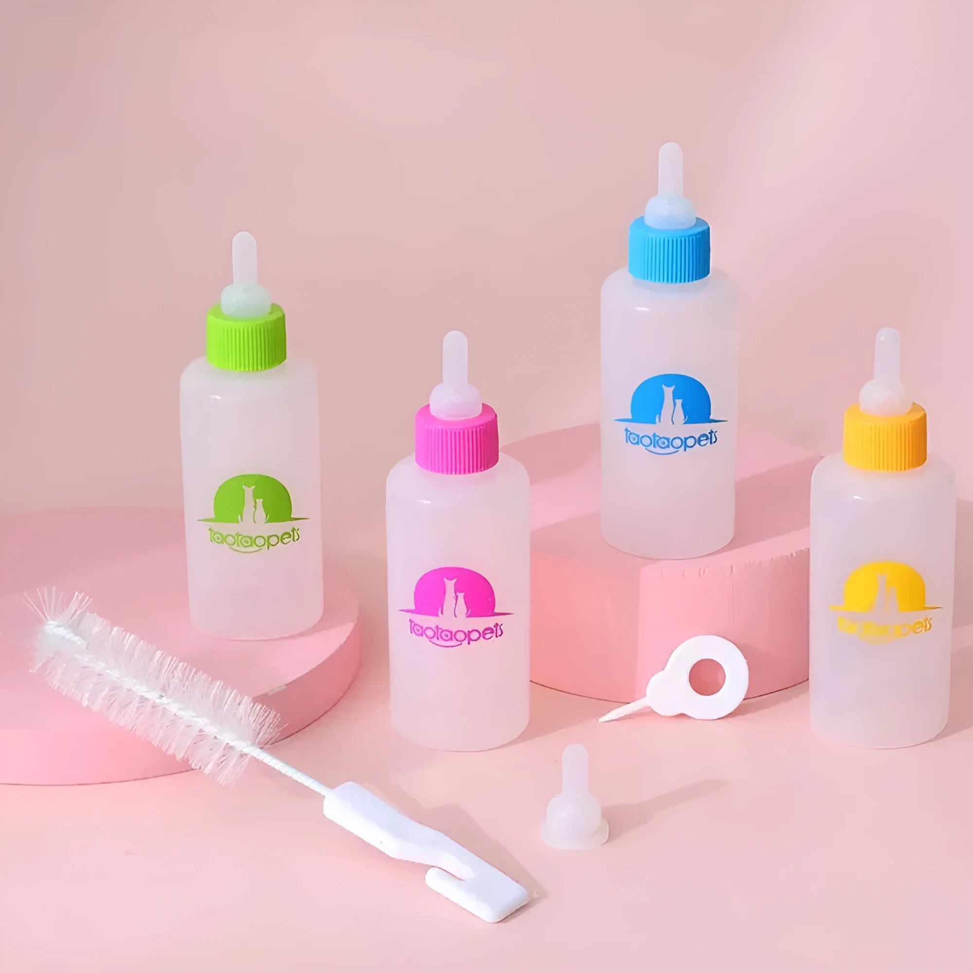 Set of four coloured pet milk bottles with a cleaning brush for feeding newborn puppies and kittens.