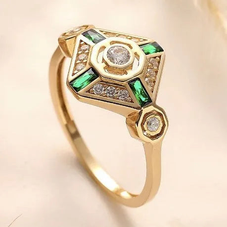 Square-shaped women's ring with a green emerald gemstone on a geometric band.