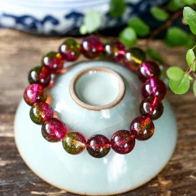 Women's handmade watermelon crystal bracelet showing pastoral design elements on wrist