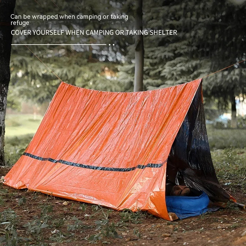 Emergency disaster relief tent kit with sleeping bag and raincoat in orange and green colours