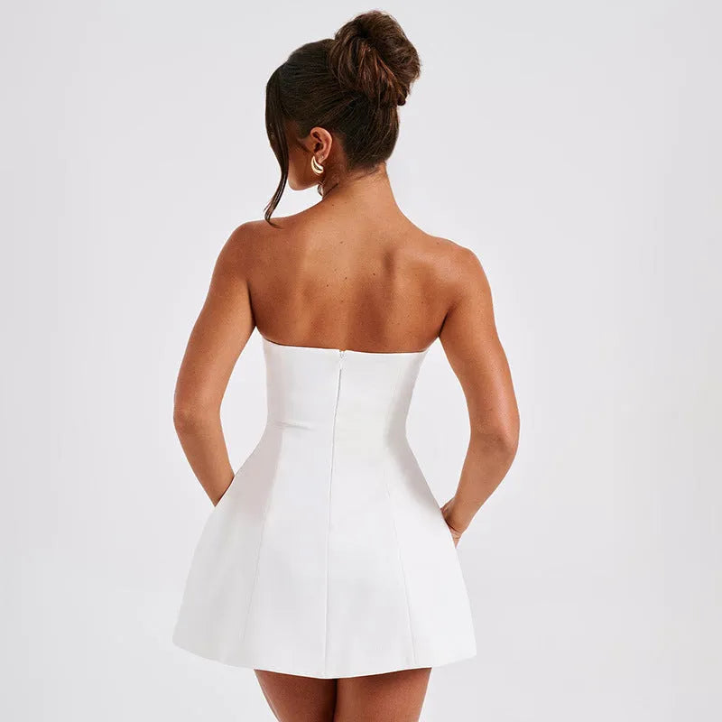 Women's black backless tube dress with short A-line skirt on a hanger.