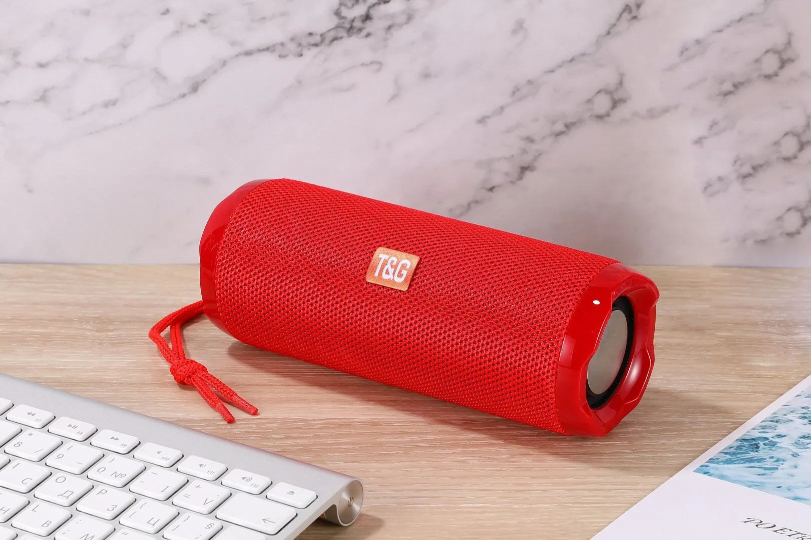 Blue portable Bluetooth speaker with a fabric card holder on the front