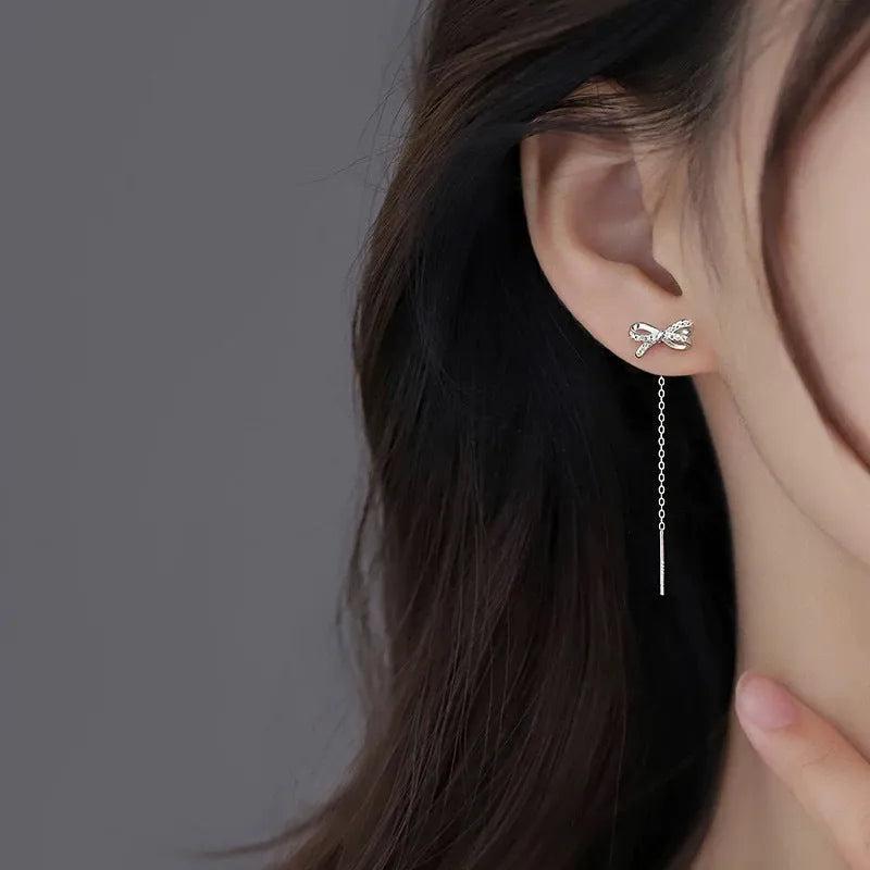 Women's white K bow earrings with long tassel ear thread, copper construction
