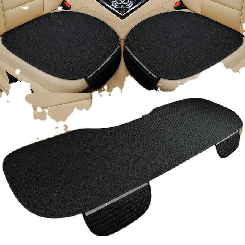 Linen car seat cushion in charm coffee colour, showing hemming detail, on a car seat.