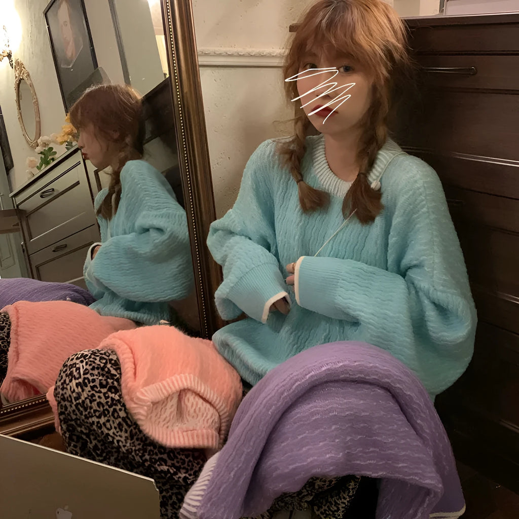 Women's lake blue loose retro pullover sweater on a hanger, showing its regular sleeves and solid colour.