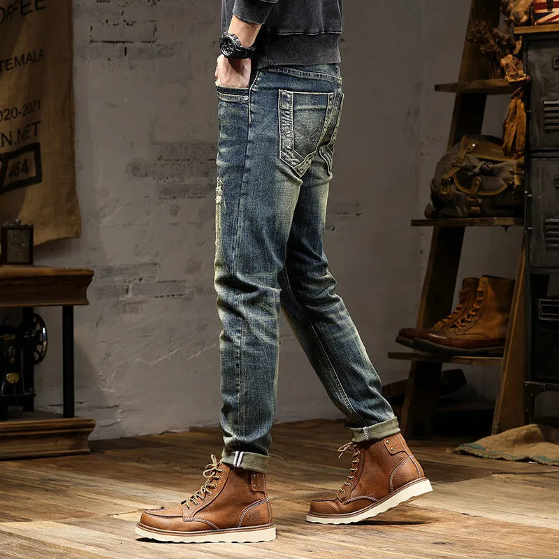 Men's skinny fit retro blue jeans with a zip fly closure laid flat.