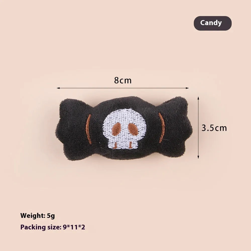 Small cat teaser wand with dangling plush candy, eye, and skull toy attachments