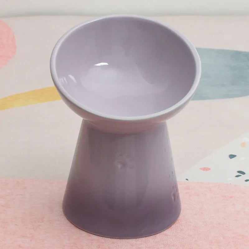 Black chin-high foot ceramic pet bowl for dogs and cats on a flat surface.
