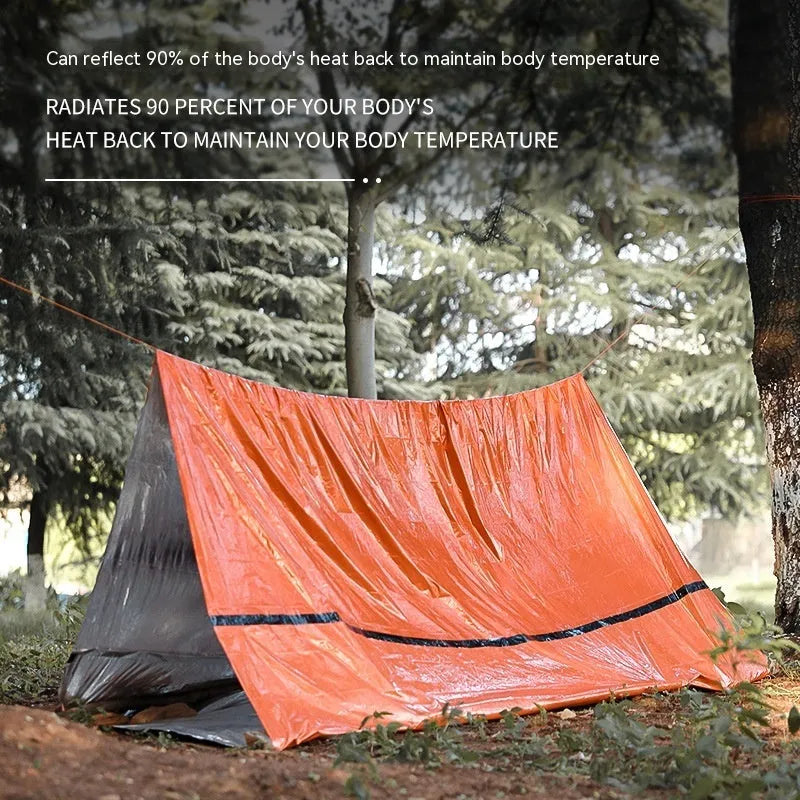 Emergency disaster relief tent kit with sleeping bag and raincoat in orange and green colours