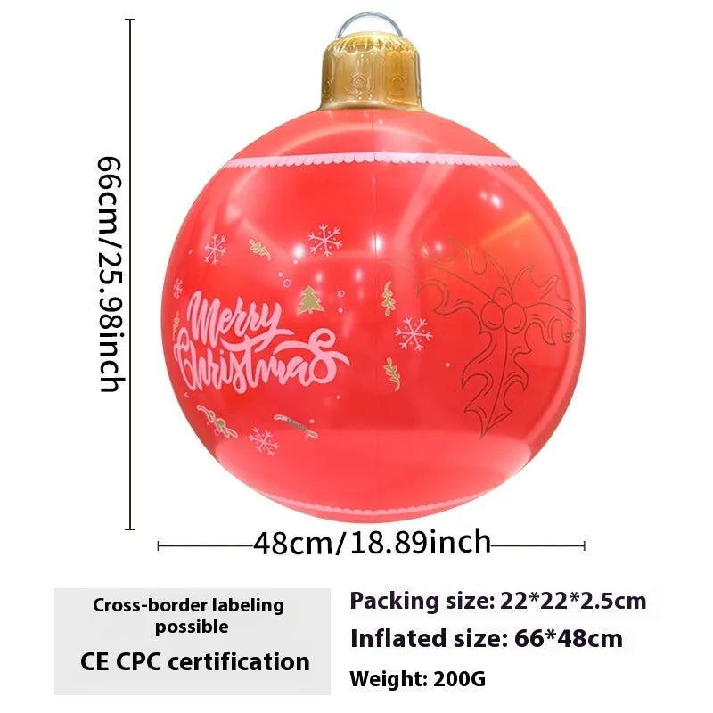 Large red and white inflatable Christmas ball with flashing lights in a garden setting.