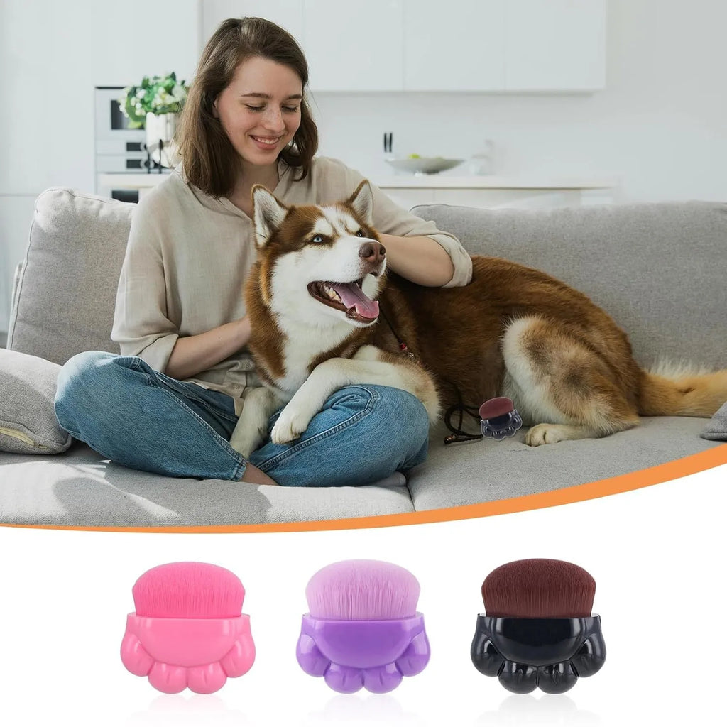 Three small pet paw-shaped balm brushes with soft fibre heads and plastic storage boxes.
