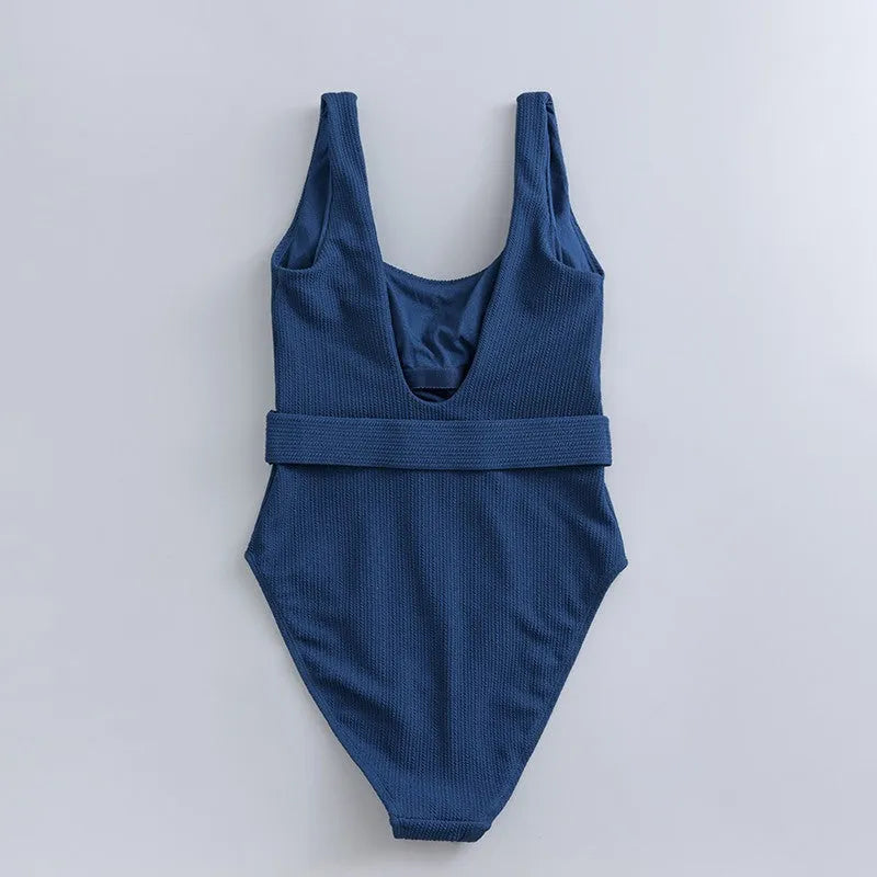 Navy blue women's one-piece swimsuit with slimming triangle design and built-in chest pad