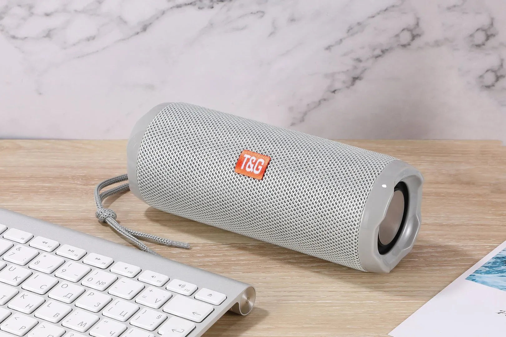 Blue portable Bluetooth speaker with a fabric card holder on the front