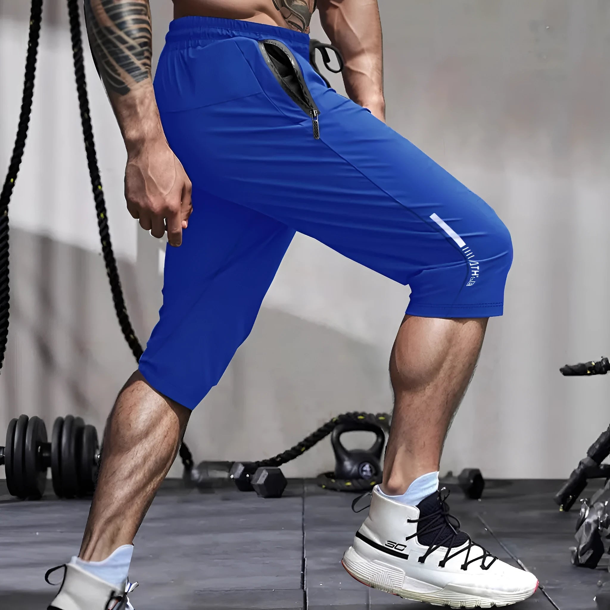 Men's cropped nylon sports trousers in straight cut available in black, blue, gray and khaki
