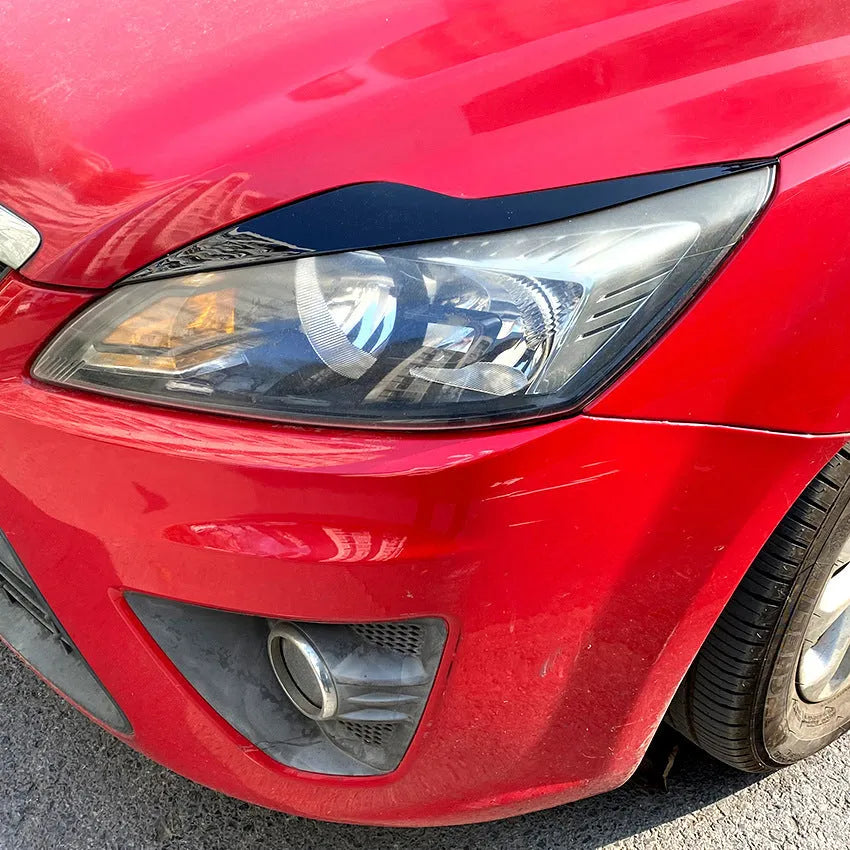 Ford Focus front headlight with carbon fiber pattern ABS eyebrow decal applied for external decorative modification