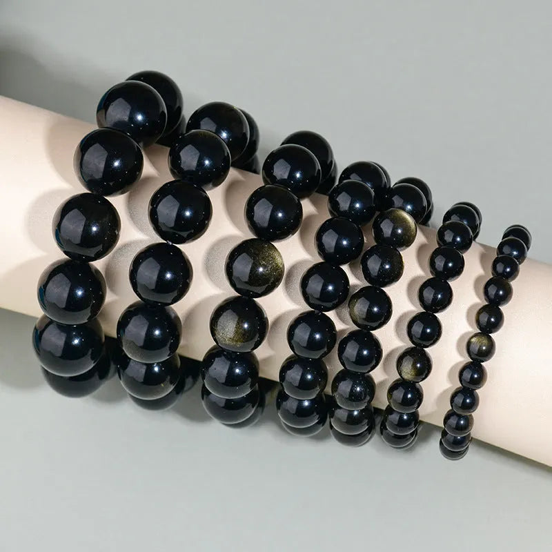 Hand-woven obsidian couple bracelet with year of birth symbols in ethnic style design