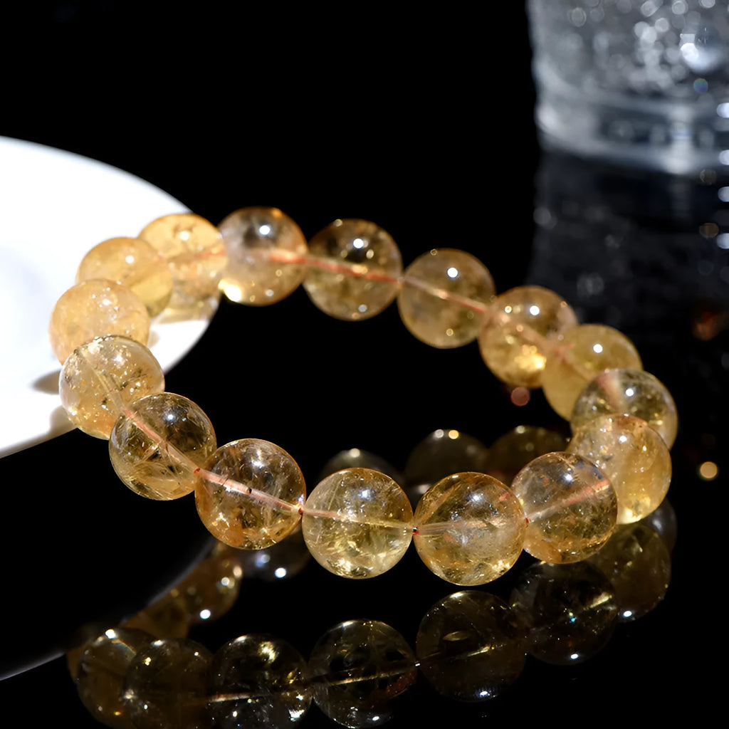 Natural yellow citrine gemstone bracelet showing geometric beads on a string.