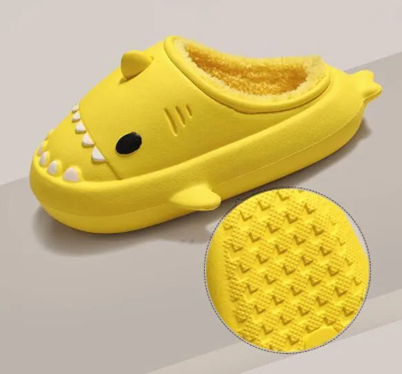 Winter soft bottom household couple EVA cartoon shark cotton slippers in blue, grey, pink on a floor