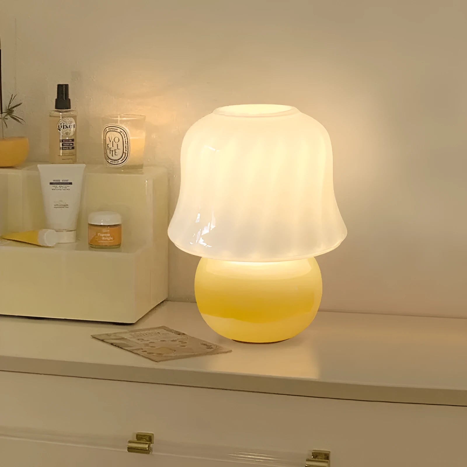 Handmade glazed glass mushroom lamp in cream yellow with push button switch on bedside table