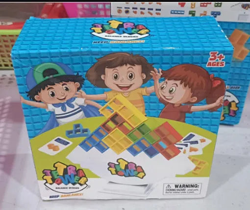 Plastic balance stacking board game with 16 coloured building blocks, chassis, and base on table.