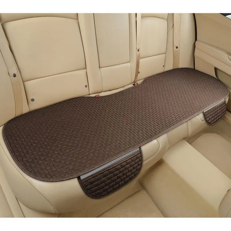Linen car seat cushion in charm coffee colour, showing hemming detail, on a car seat.