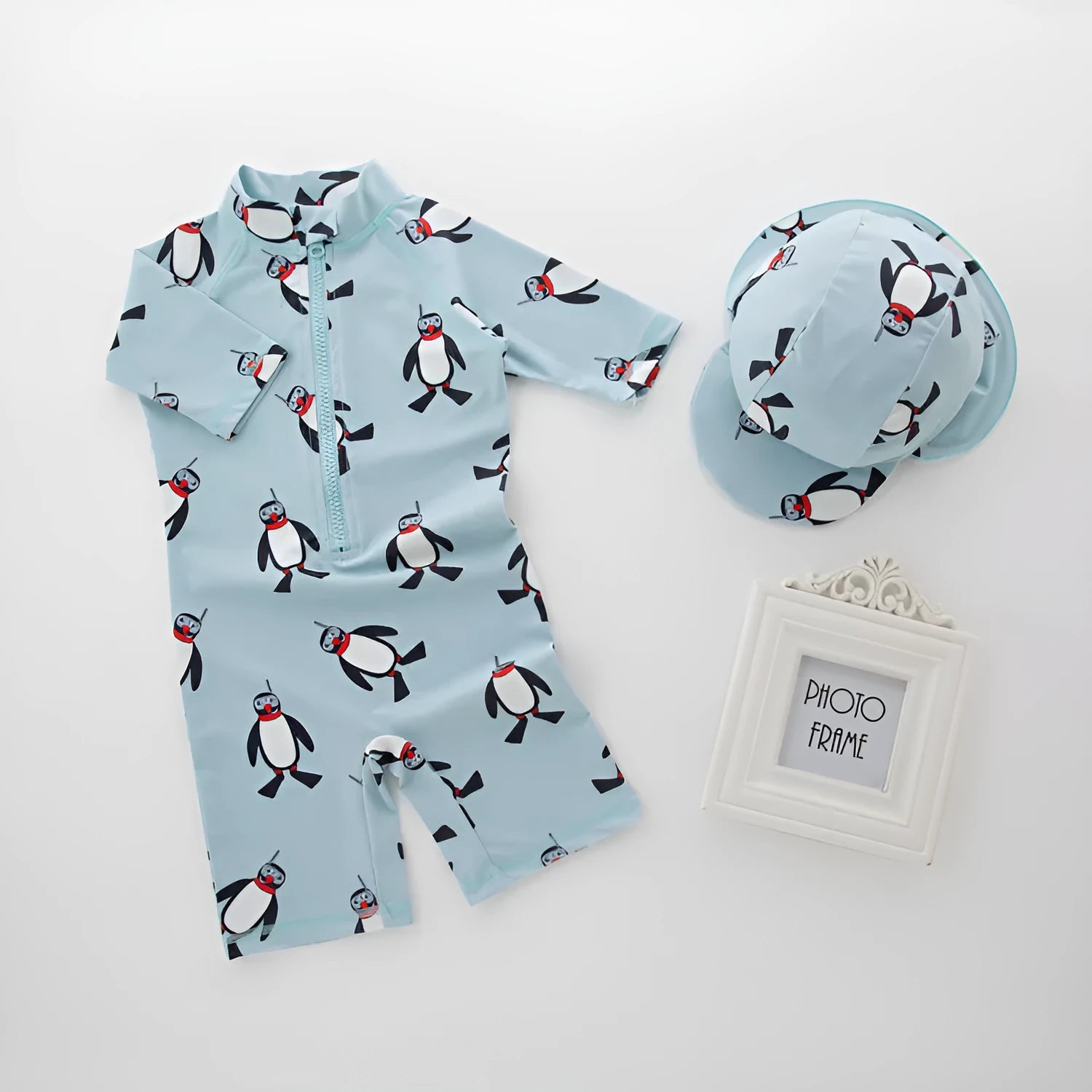 Boy's penguin print long sleeve swimsuit two-piece set with matching swimming cap