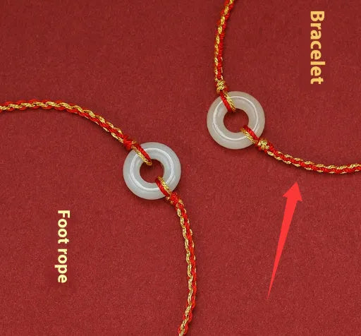 Red rope braided bracelet with natural wave-shaped Hetian jade pendant for Tiger Year birth year, on a neutral background