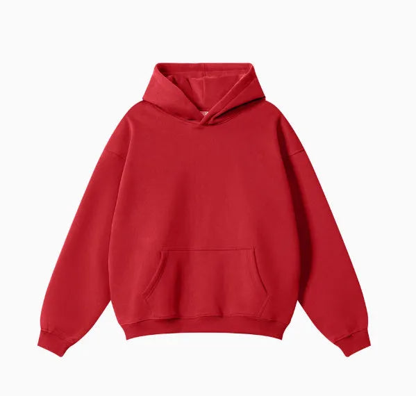 Man wearing a grey heavyweight cotton terry hooded sweater with a loose fit and drop-shoulder sleeves.