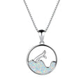 A round geometric fishtail pendant necklace with a white gold electroplated finish, shown in blue opal and white opal colour options.