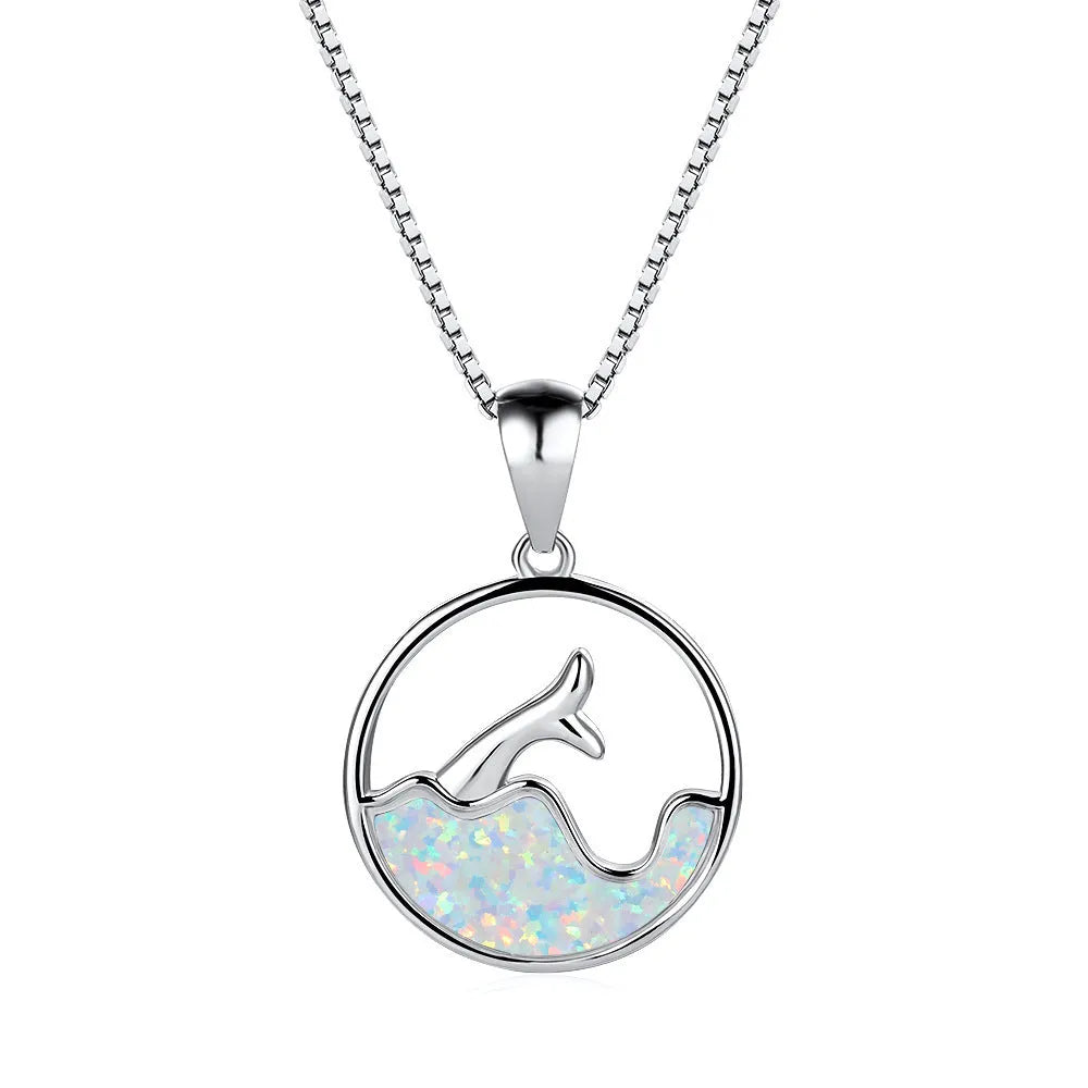 A round geometric fishtail pendant necklace with a white gold electroplated finish, shown in blue opal and white opal colour options.