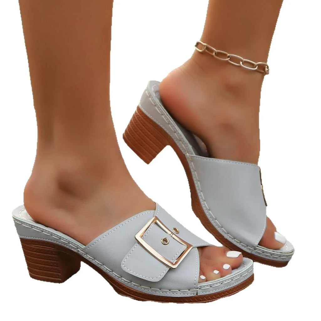 Women's black chunky heel slippers with silver metal buckle and round toe