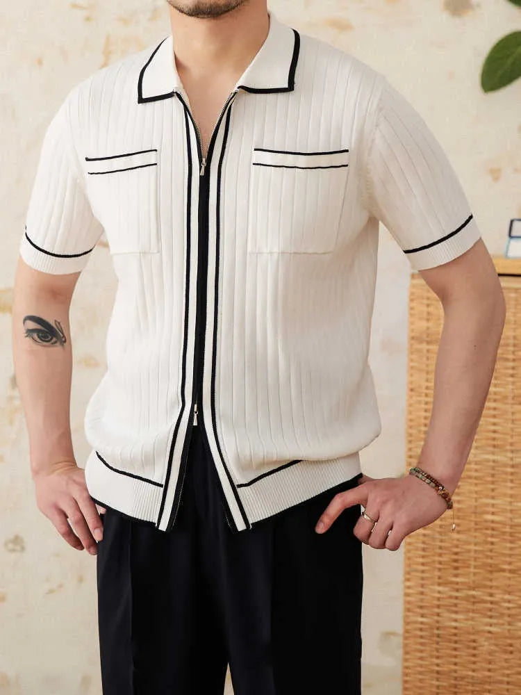 Man wearing a slim fit black knitted polo shirt with a lapel collar and short sleeves.