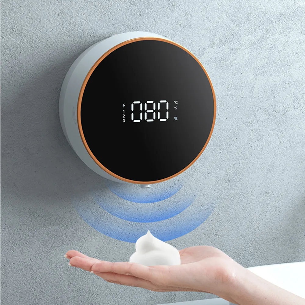 Black automatic sensor foam soap dispenser mounted on a white bathroom wall