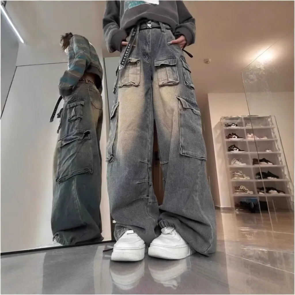 Loose fit light blue denim jeans with multiple pockets and a distressed washed finish on a neutral background.