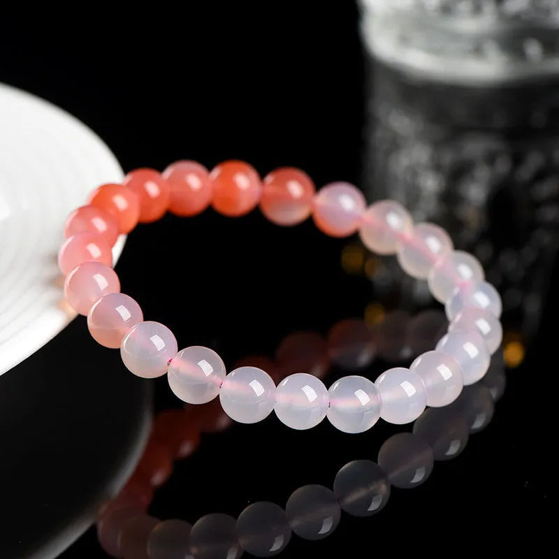 Natural gradient Yanyuan agate bracelet with geometry-shaped beads on a wrist.